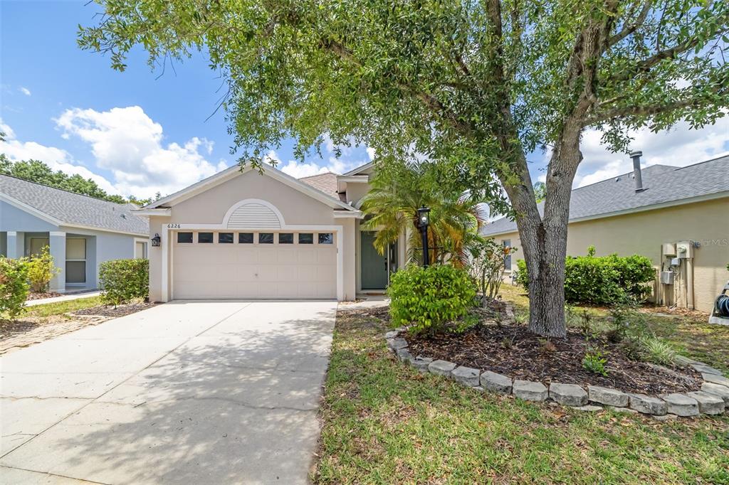 6226 Blueflower Court Lakewood Ranch, FL 34202 - Photo 54 of 81 a front view of a house with a yard and garage