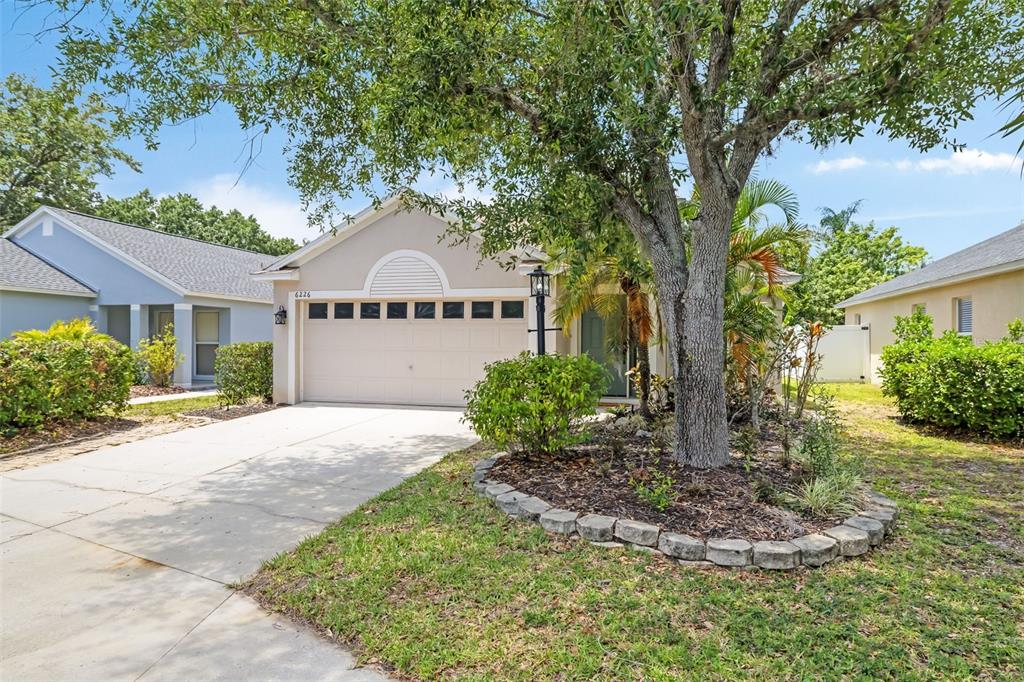 6226 Blueflower Court Lakewood Ranch, FL 34202 - Photo 55 of 81 a front view of a house with a yard and garage