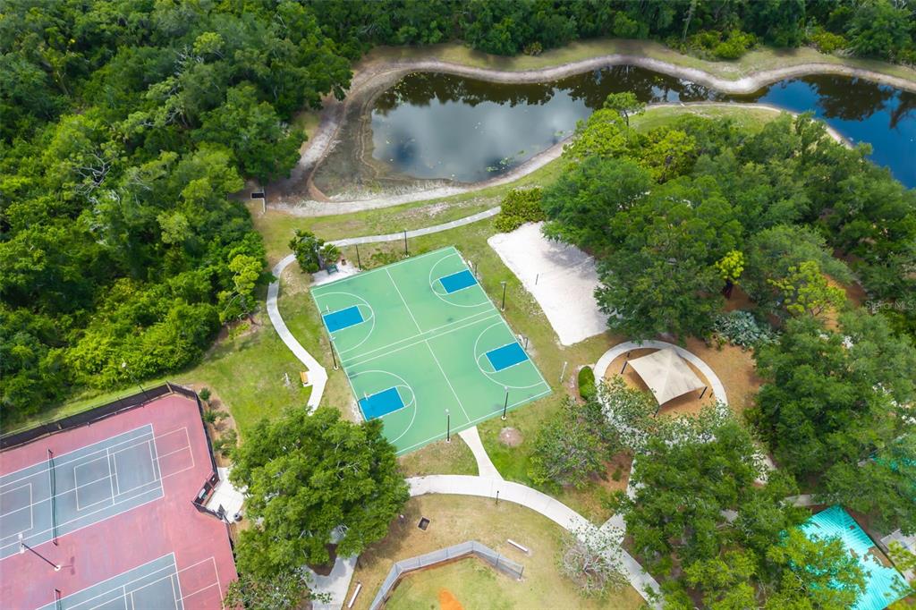 6226 Blueflower Court Lakewood Ranch, FL 34202 - Photo 60 of 81 an aerial view of a house with a yard and lake view