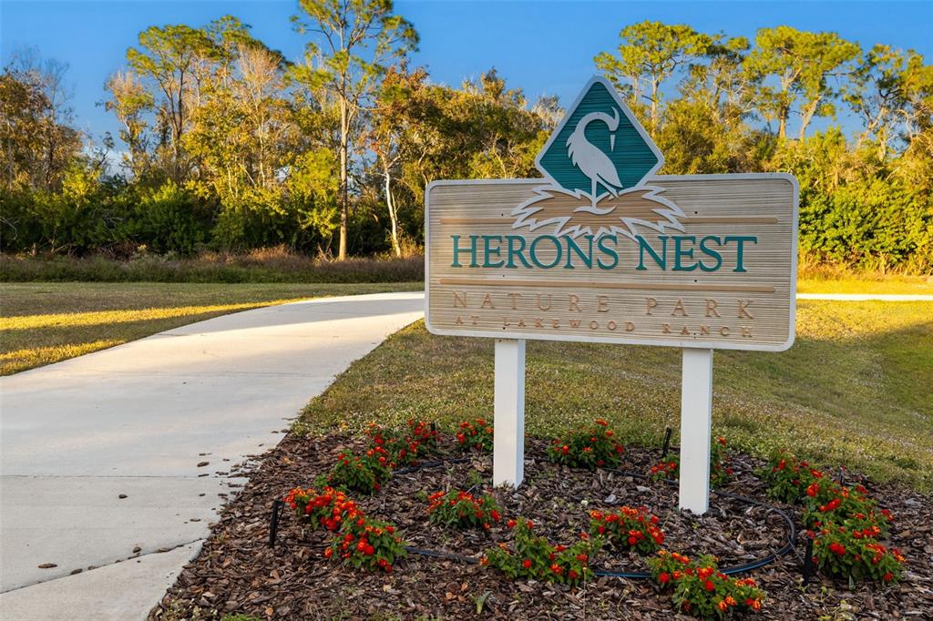 6226 Blueflower Court Lakewood Ranch, FL 34202 - Photo 64 of 81 a view of a street sign under a tree