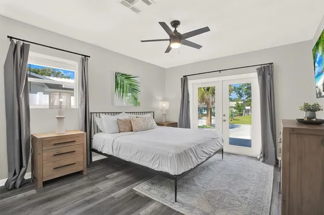 a bedroom with a large bed and a chandelier