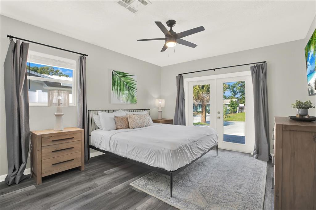 1241 12th Court Southwest Largo, FL 33770 - Photo 12 of 32 a bedroom with a large bed and a chandelier