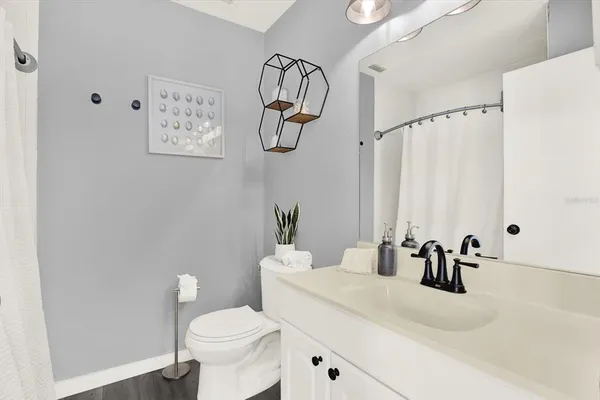 a bathroom with a sink vanity mirror and toilet