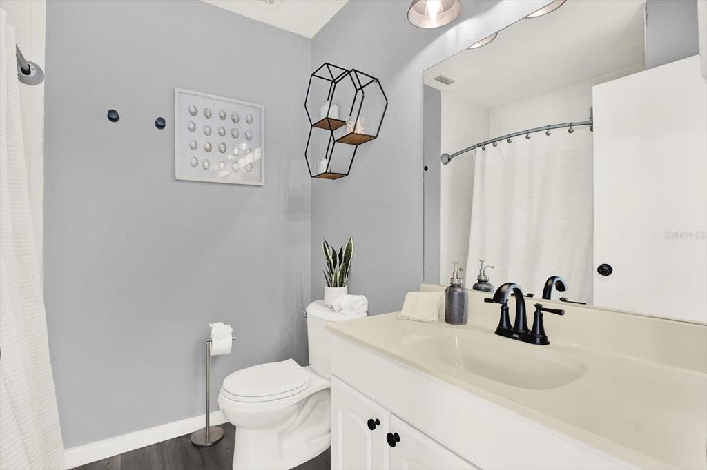 1241 12th Court Southwest Largo, FL 33770 - Photo 13 of 32 a bathroom with a sink vanity mirror and toilet
