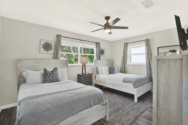 a bedroom with two beds and a window