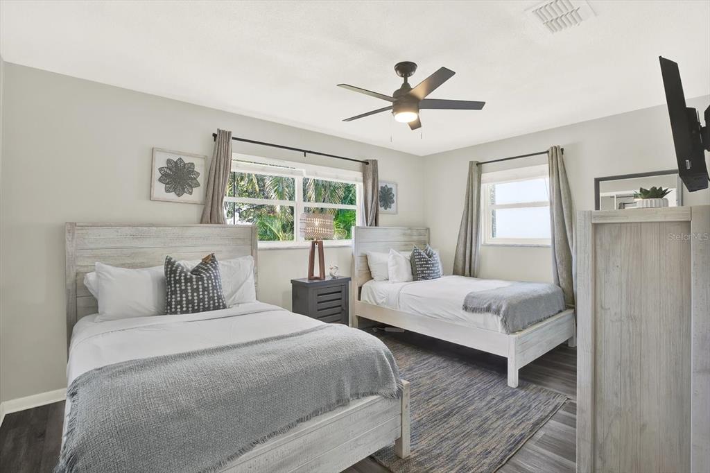 1241 12th Court Southwest Largo, FL 33770 - Photo 14 of 32 a bedroom with two beds and a window