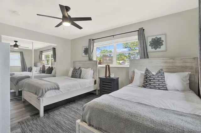 a bedroom with two beds and a large mirror