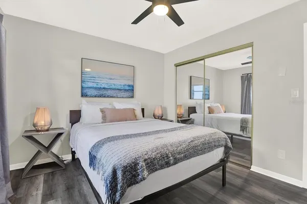 a bedroom with a bed and wooden floor