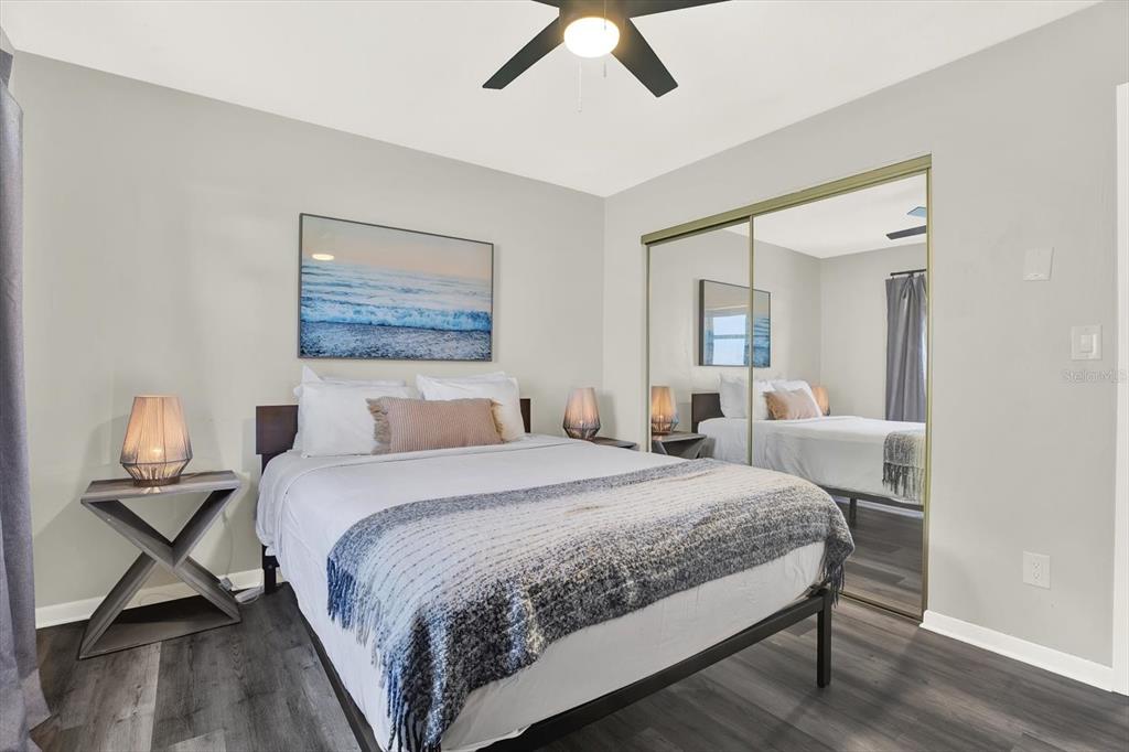 1241 12th Court Southwest Largo, FL 33770 - Photo 16 of 32 a bedroom with a bed and wooden floor