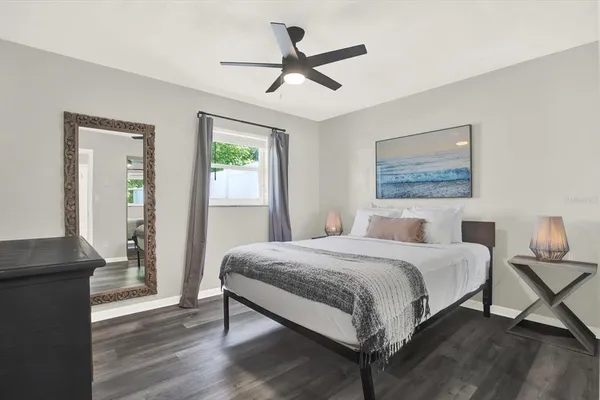 a bedroom with a bed and a chandelier