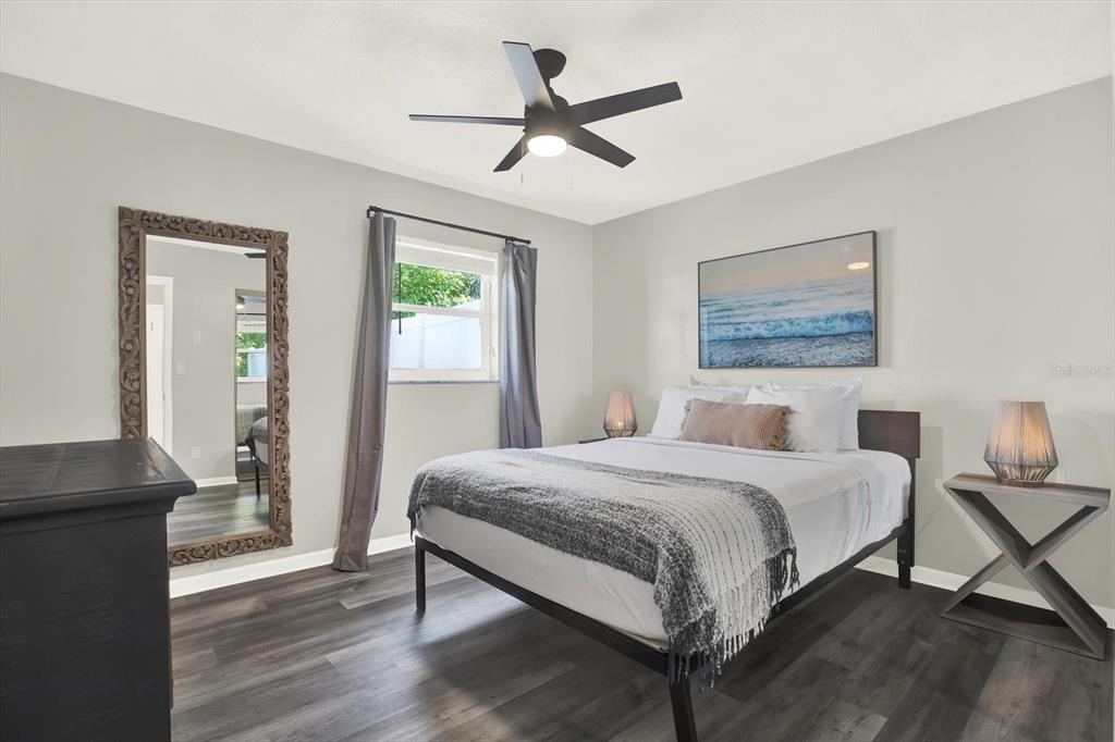 1241 12th Court Southwest Largo, FL 33770 - Photo 17 of 32 a bedroom with a bed and a chandelier
