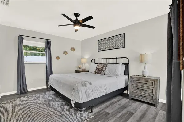 a bedroom with a bed and a night stand