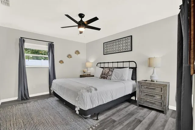 a bedroom with a bed and a night stand