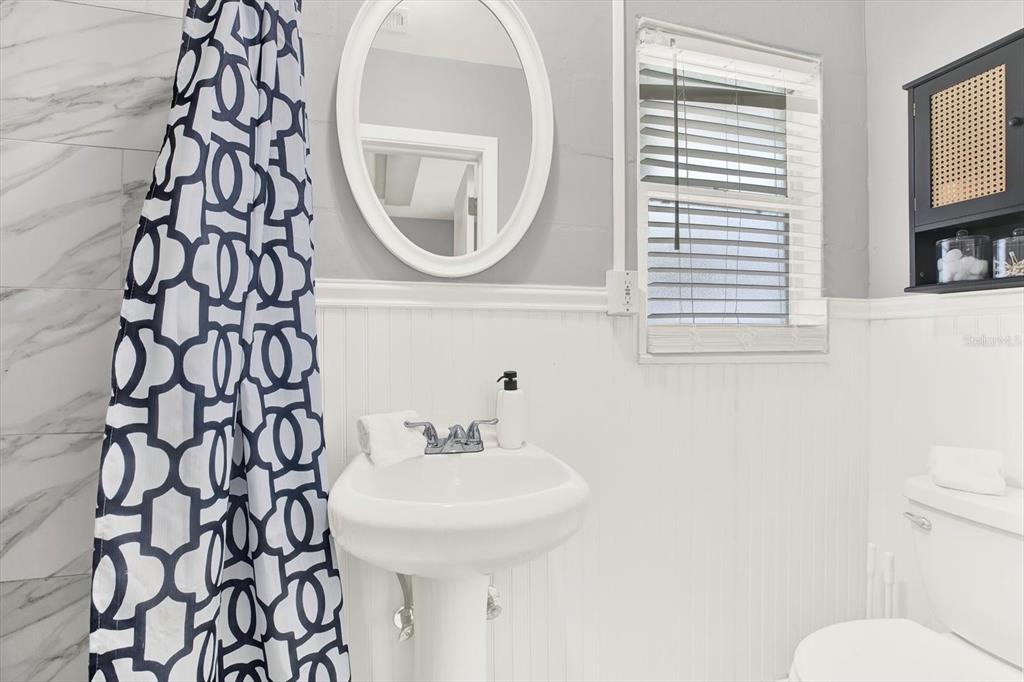 1241 12th Court Southwest Largo, FL 33770 - Photo 21 of 32 a bathroom with a sink and a mirror