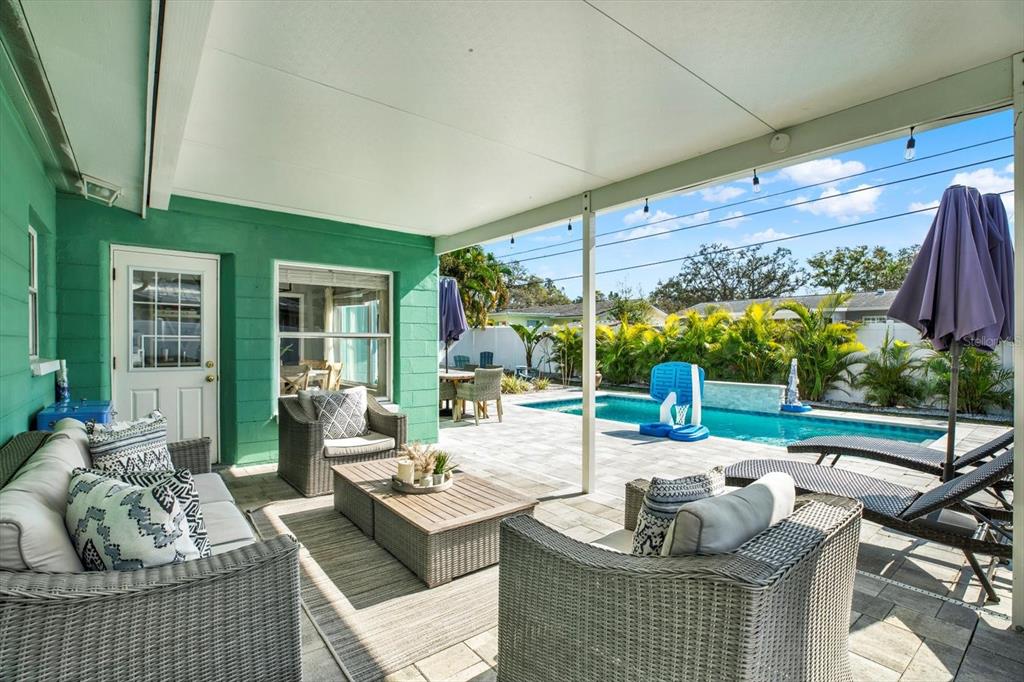 1241 12th Court Southwest Largo, FL 33770 - Photo 22 of 32 a living room with patio furniture and a floor to ceiling window