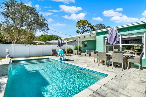 a view of a swimming pool with a patio