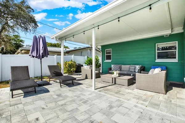 a building outdoor space with patio furniture and potted plants
