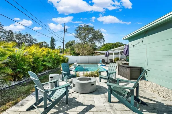a view of a chairs and table in backyard