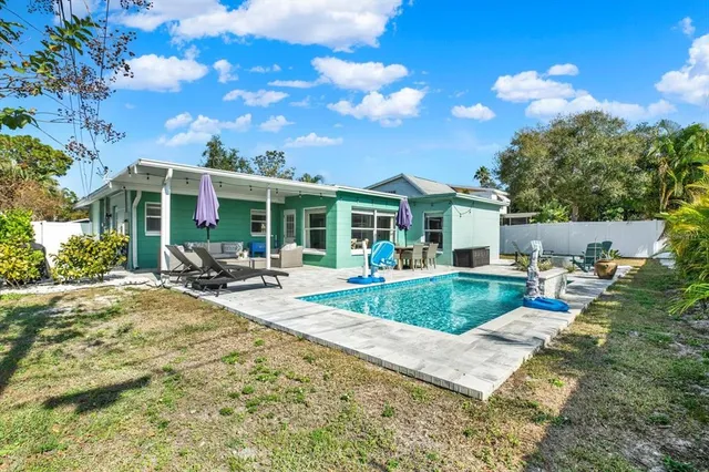 a view of a house with backyard porch and sitting area