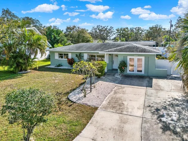 a view of a house with backyard and sitting area