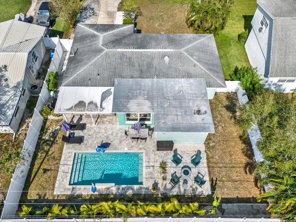 an aerial view of a house with a swimming pool
