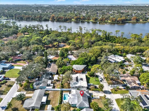 an aerial view of lake and residential houses with outdoor space
