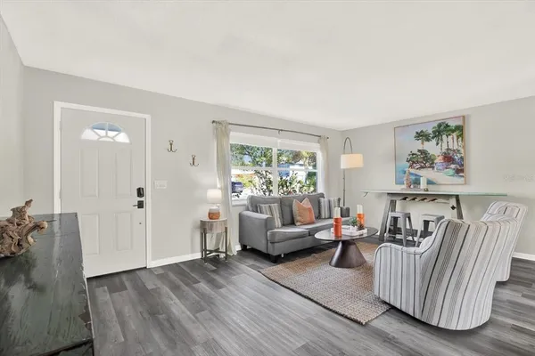 a living room with furniture and wooden floor