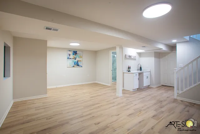 a view of a kitchen with wooden floor and windows