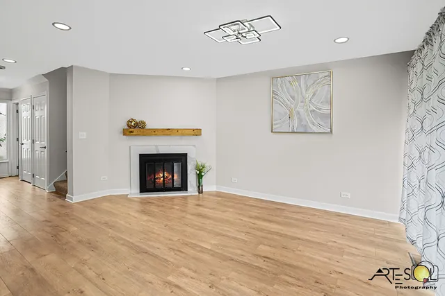 a view of an empty room with a fireplace