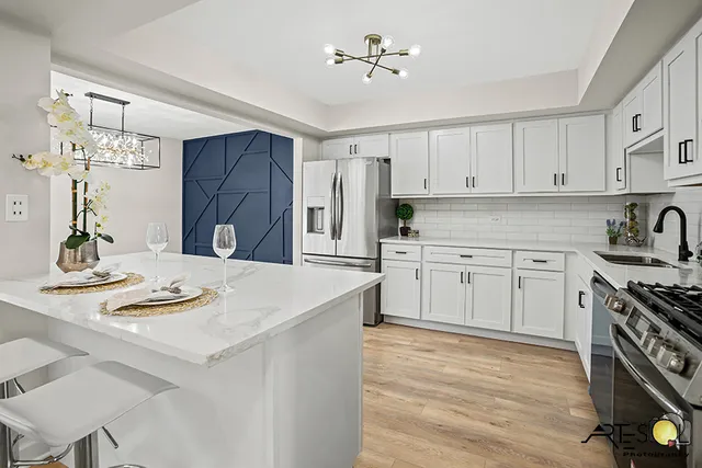 a kitchen with a white stove cabinets and wooden floor