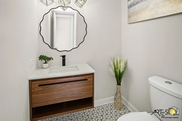 a bathroom with a sink a toilet and a mirror