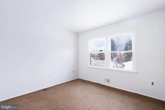 an empty room with a empty space and a window