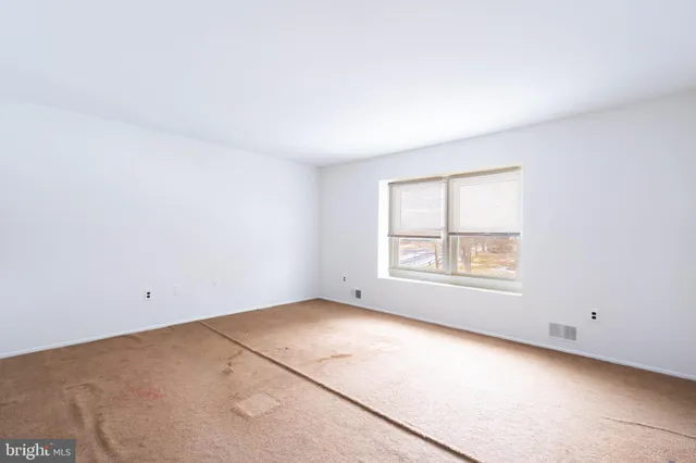 a view of empty room with wooden walls