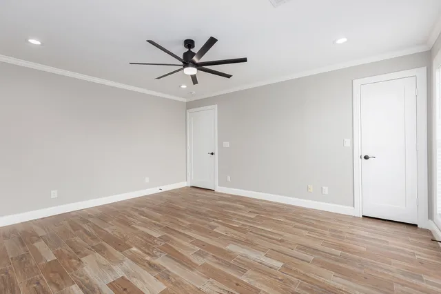 a view of a kitchen with wooden floor and a window
