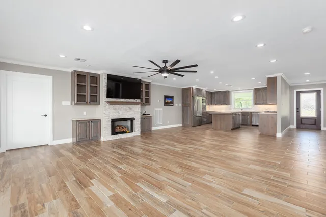a kitchen with wooden cabinets sink and stove