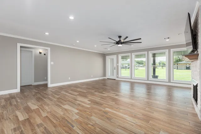 a spacious bedroom with a bed and a window