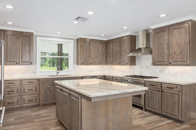 a bathroom with a toilet sink vanity and mirror