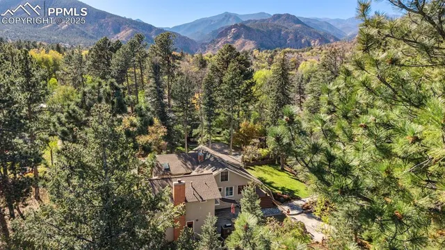 a view of a house with a yard and mountain