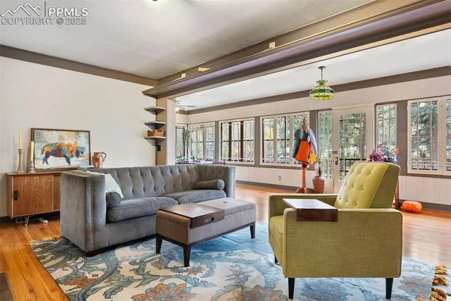 a living room with furniture and a floor to ceiling window