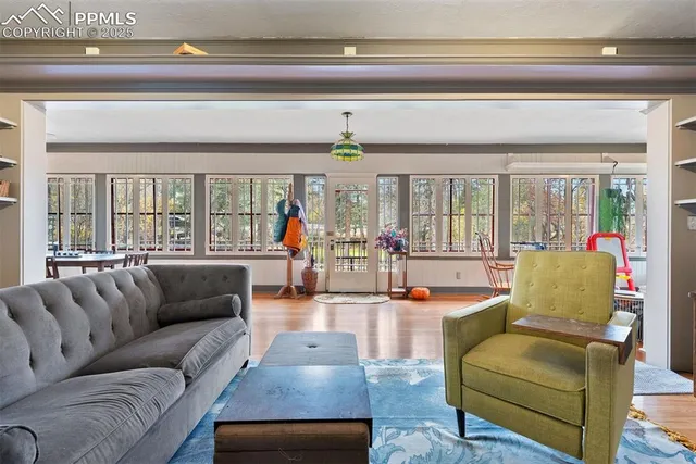 a living room with furniture and a chandelier