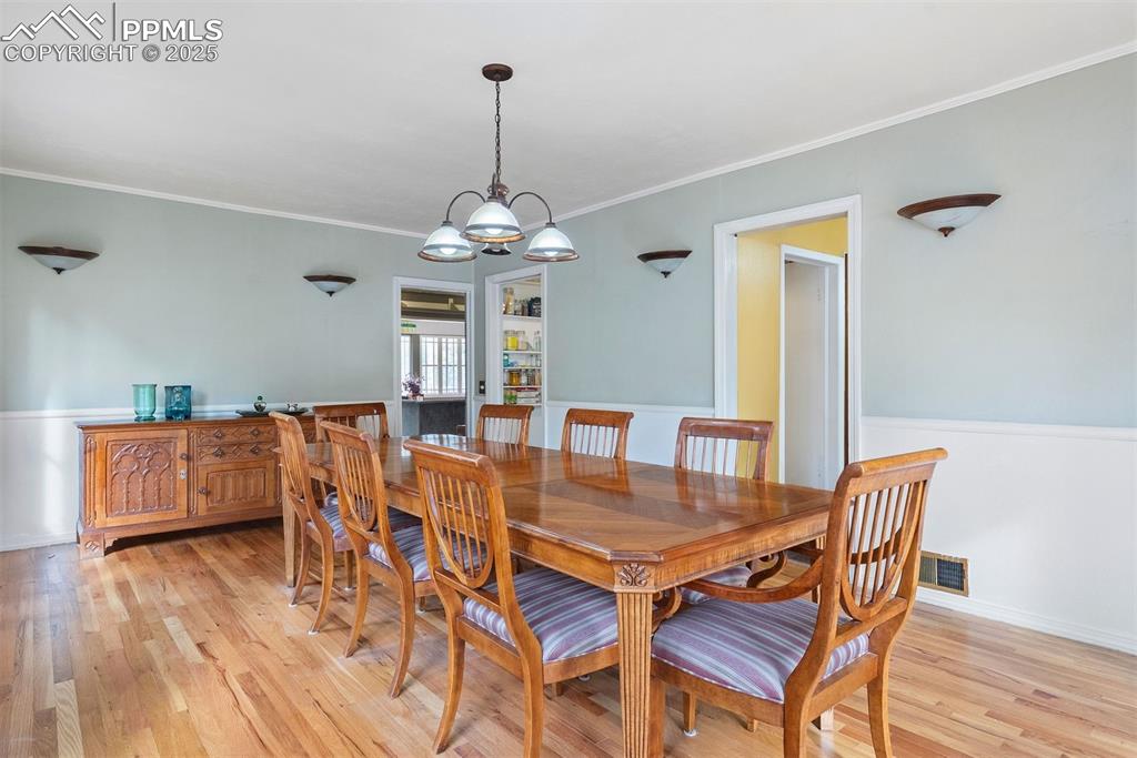 1515 West Cheyenne Road Colorado Springs, CO 80906 - Photo 20 of 50 a view of a dining room with furniture and wooden floor