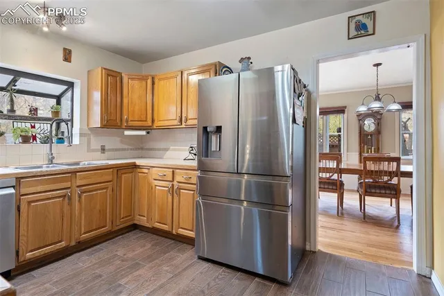 a kitchen with stainless steel appliances granite countertop a refrigerator sink and cabinets