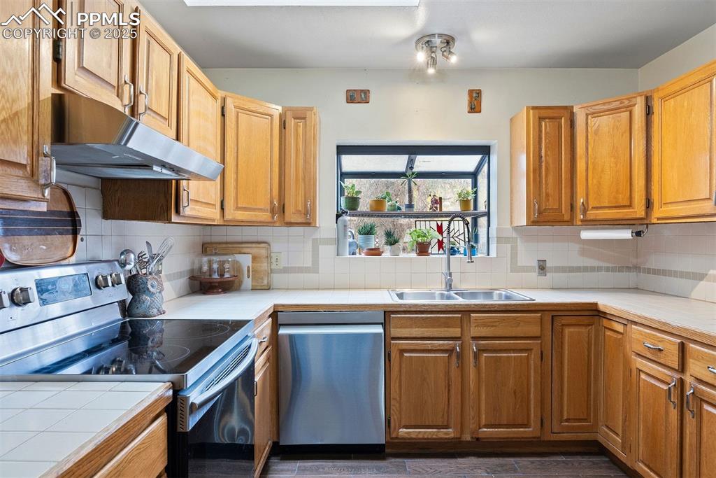 1515 West Cheyenne Road Colorado Springs, CO 80906 - Photo 22 of 50 a kitchen with cabinets appliances a sink and a window