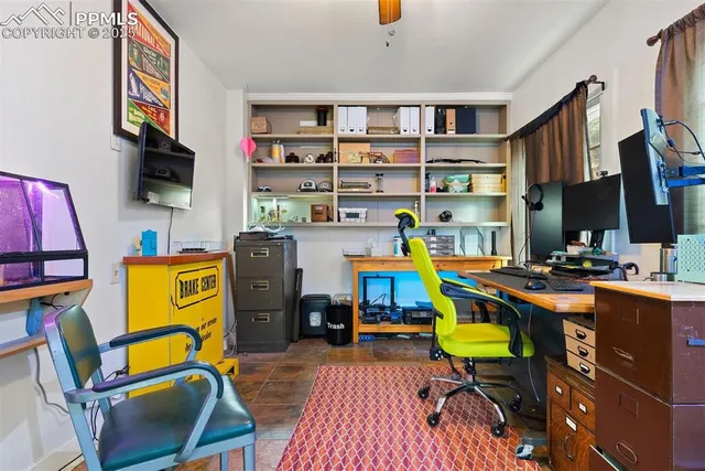 a view of a workspace with furniture and toys