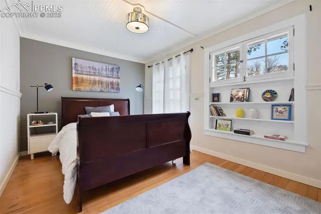 a bedroom with a bed and a bookshelf