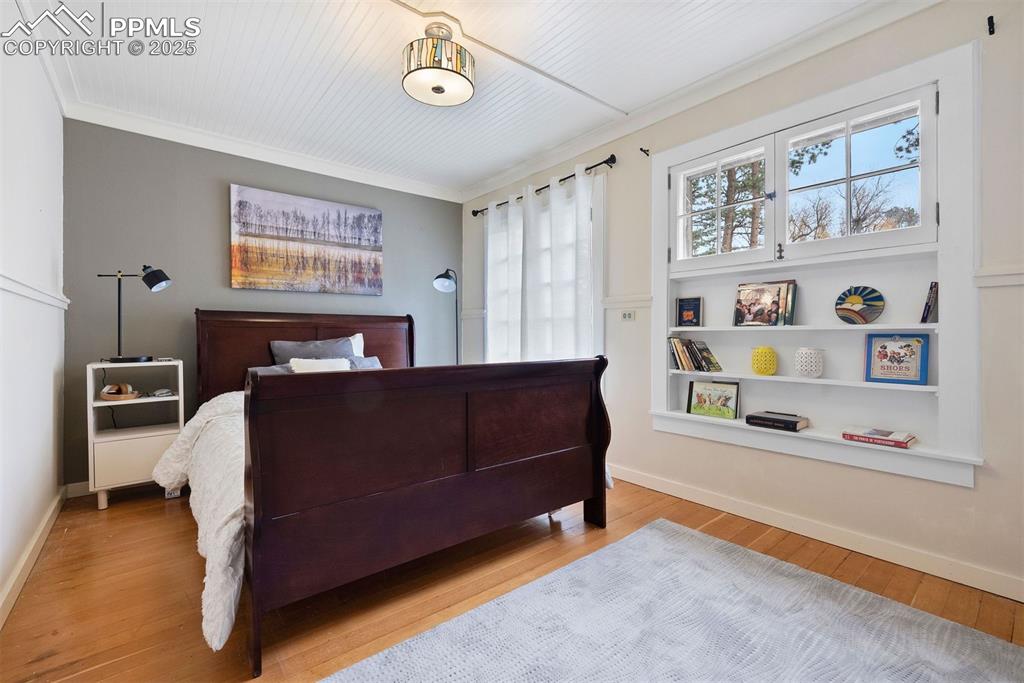1515 West Cheyenne Road Colorado Springs, CO 80906 - Photo 25 of 50 a bedroom with a bed and a bookshelf