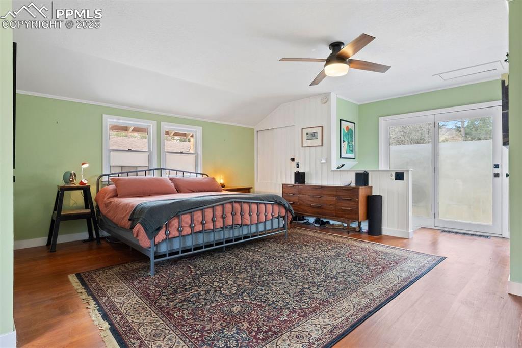 1515 West Cheyenne Road Colorado Springs, CO 80906 - Photo 27 of 50 a bedroom with a bed and wooden floor