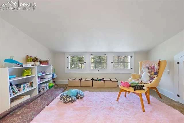 a living room with furniture cabinets and a window