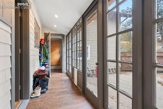 a hallway with sliding door and wooden floor