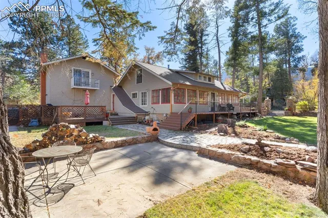 a view of a house with a yard siting and trees